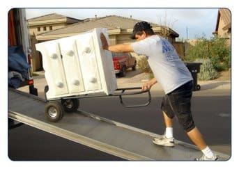 mover loading furniture on moving truck